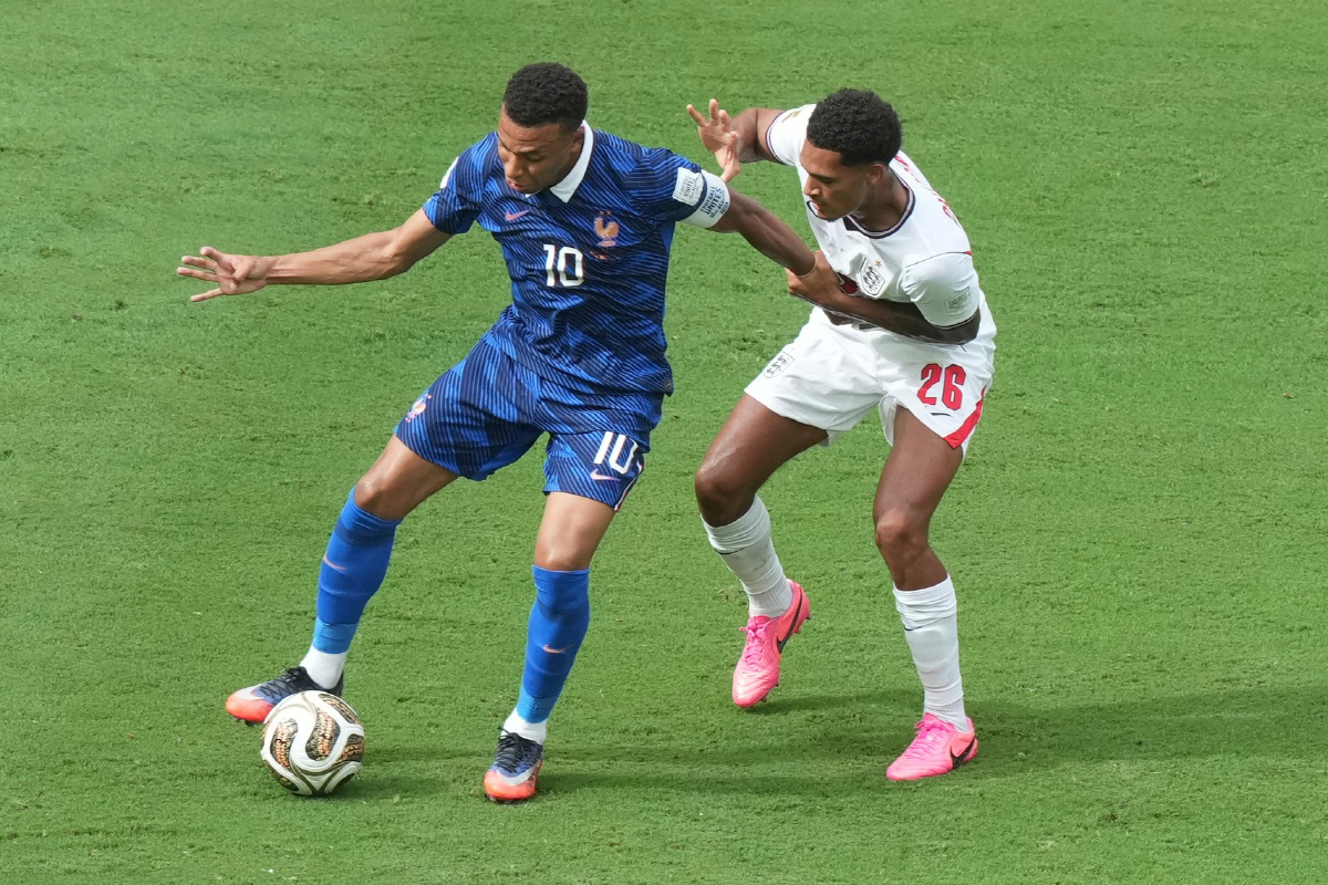 France's Kylian Mbappe (10) moves the ball past England's Jarell Quansah (26) during the World Cup third-place playoff soccer match between France and England in Miami Gardens, Fla., Saturday, July 18, 2026. (AP Photo/Marta Lavandier)