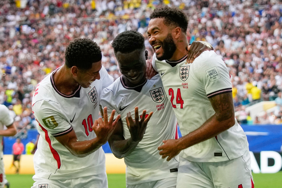 England's Bukayo Saka (7) is congratulated by Jude Bellingham (10) and Reece James (24) after scoring his side's 5th goal from the penalty spot during the World Cup third-place playoff soccer match between France and England in Miami Gardens, Fla., Saturday, July 18, 2026. (AP Photo/Lynne Sladky)