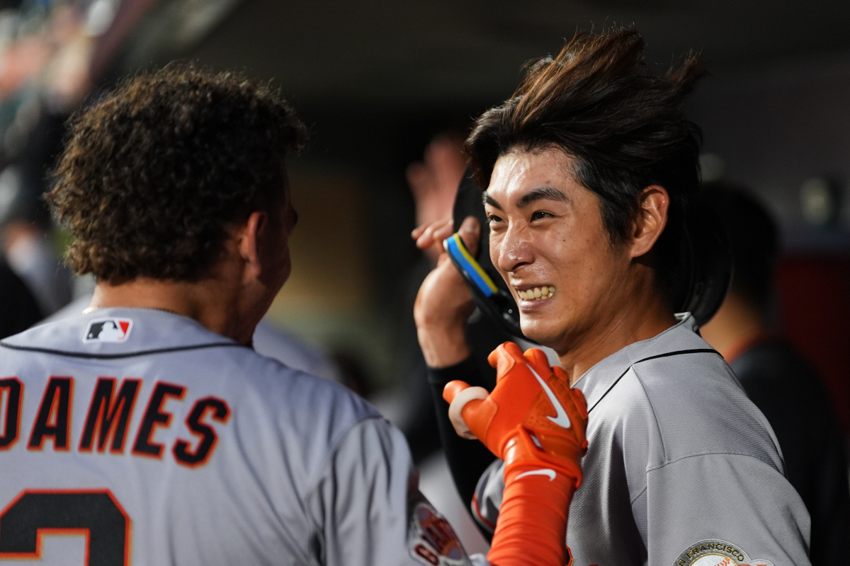 San Francisco Giants' Willy Adames, left, celebrates in the dugout with Jung Hoo Lee, right, after hitting a grand slam against the Seattle Mariners during the seventh inning of a baseball game, Friday, July 17, 2026, in Seattle. (AP Photo/Lindsey Wasson)