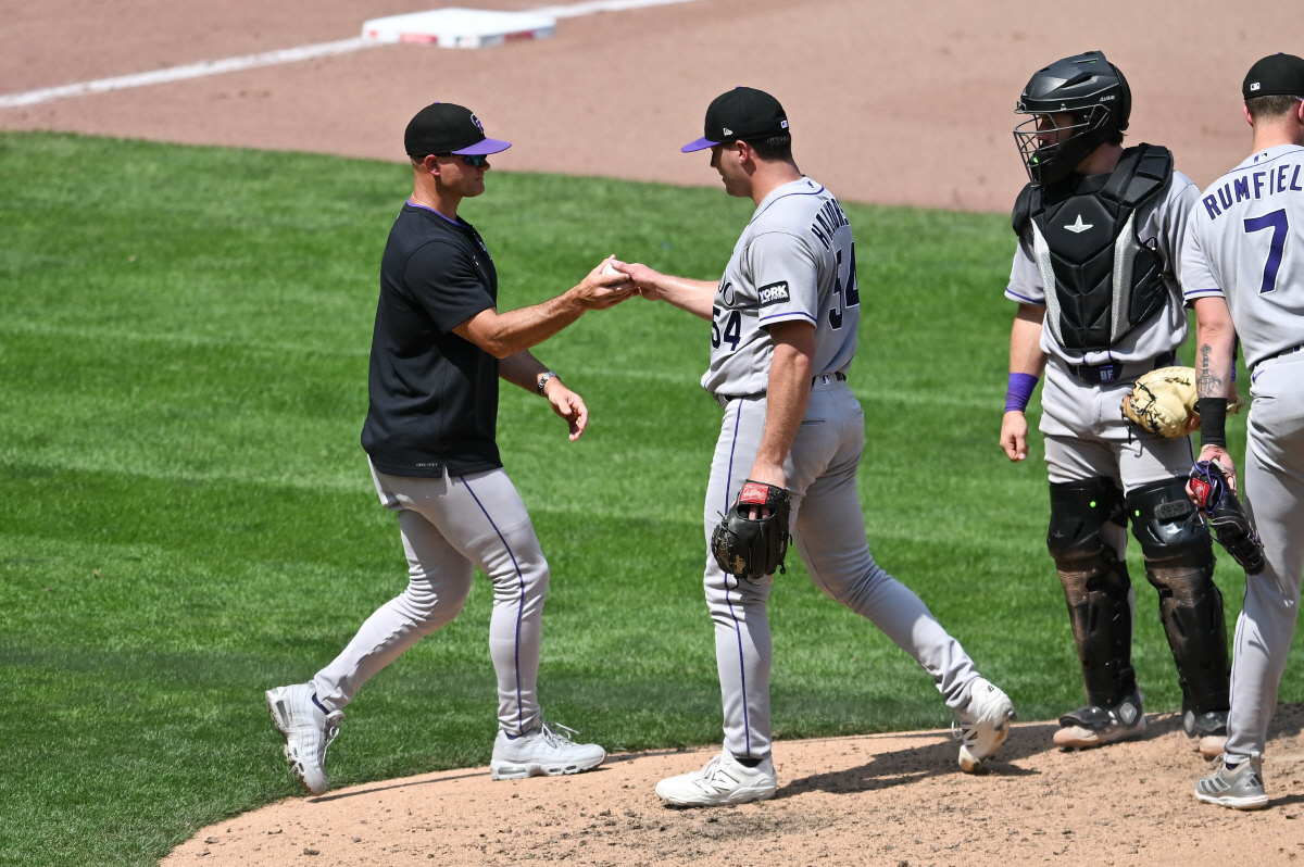 MINNEAPOLIS, MINNESOTA - JUNE 28: Manager Warren Schaeffer #4 of the Colorado Rockies takes the ball from Seth Halvorsen #54 against the Minnesota Twins during the seventh inning of the game at Target Field on June 28, 2026 in Minneapolis, Minnesota. Stephen Maturen/Getty Images/AFP (Photo by Stephen Maturen / GETTY IMAGES NORTH AMERICA / Getty Images via AFP)